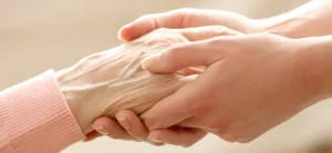 picture of young adult hands holding elderly hands