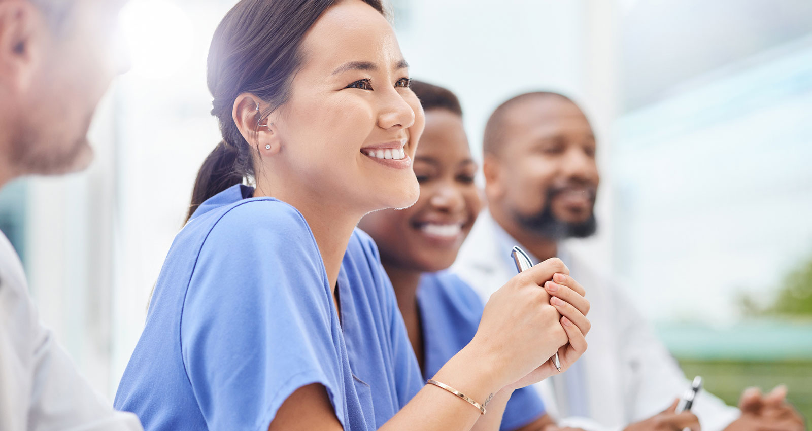 Nurse smiling amongst peers