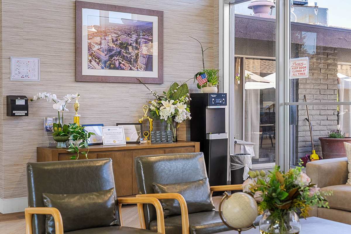 Modern waiting area with plants, awards, and comfortable seating.
