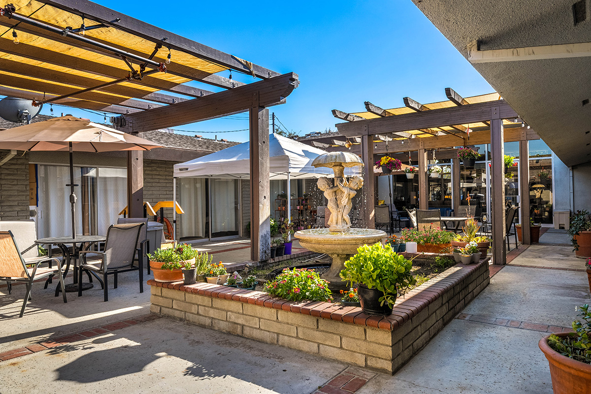 Charming courtyard with a fountain and lush greenery.